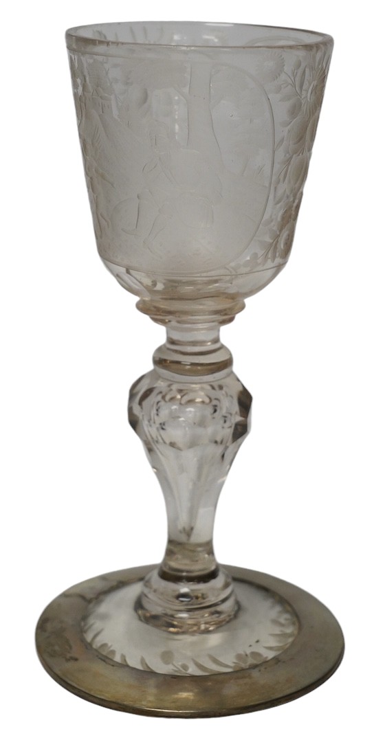 A Victorian engraved tall stemmed wine glass with white metal mounted foot rim, 22cm high. Condition - fair to good